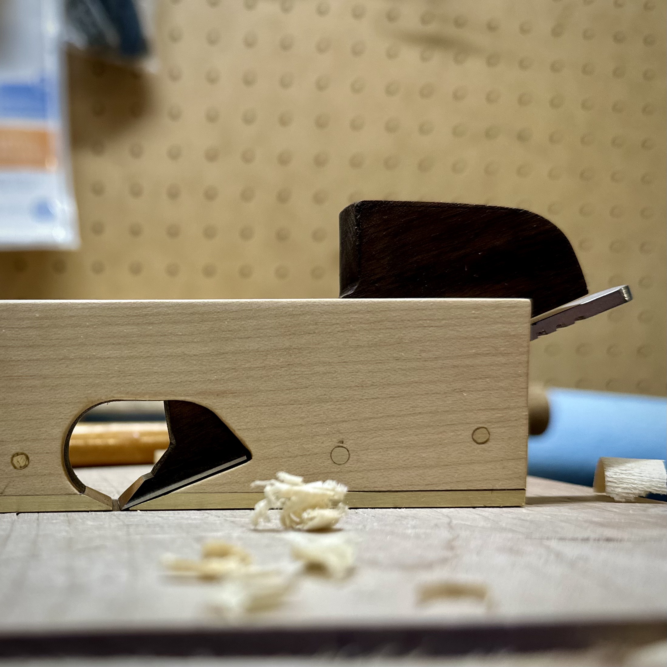 Minimalist, Custom Shoulder Plane on a woodworking shooting board, in a worskshop